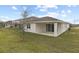 House exterior with covered patio and grassy yard at 3345 Chicory Ct, Lake Hamilton, FL 33851