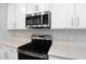 Stainless steel appliances and white cabinets in this kitchen at 3345 Chicory Ct, Lake Hamilton, FL 33851