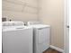 Laundry room features washer, dryer, and overhead shelving at 3345 Chicory Ct, Lake Hamilton, FL 33851