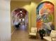 Inviting hallway with arched entryways, colorful artwork, and stylish seating for residents and guests at 4980 W Castle W St, Kissimmee, FL 34758