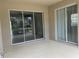 A covered patio features sliding glass doors, leading to a bright and airy indoor living space at 4980 W Castle W St, Kissimmee, FL 34758