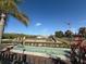 Community playground with climbing structures, swings, and slide overlooking a lake at 4980 W Castle W St, Kissimmee, FL 34758