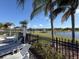 Scenic community pool area featuring lounge chairs, palm trees, and a serene lake view on a sunny day at 4980 W Castle W St, Kissimmee, FL 34758