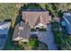 Aerial view of the house with brick driveway, solar panels, and mature landscaping at 19529 Dorr Rd, Altoona, FL 32702