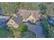 Aerial view of the house with a brick driveway, solar panels, and mature landscaping at 19529 Dorr Rd, Altoona, FL 32702