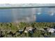 Aerial view of a lakeside home surrounded by mature trees and lush landscaping at 19529 Dorr Rd, Altoona, FL 32702