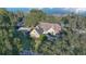 Aerial view of the house featuring solar panels, a long driveway, and mature trees at 19529 Dorr Rd, Altoona, FL 32702