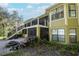 Backyard view of multi-story house with deck, stairs, and landscaping at 19529 Dorr Rd, Altoona, FL 32702