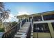 Backyard stairs lead up to a screened-in deck with a view at 19529 Dorr Rd, Altoona, FL 32702