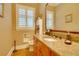 Stylish bathroom features a granite countertop, wooden cabinets, and a window with shutters at 19529 Dorr Rd, Altoona, FL 32702