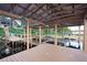 Covered boat dock featuring multiple boat lifts, wooden walkways, and access ladder at 19529 Dorr Rd, Altoona, FL 32702