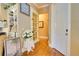 Bright hallway boasts hardwood floors, white trim, and access to multiple rooms at 19529 Dorr Rd, Altoona, FL 32702