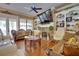 Cozy living room with a stone fireplace, built-in shelving, and large windows that bring in natural light at 19529 Dorr Rd, Altoona, FL 32702