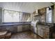 Well-equipped outdoor kitchen featuring stone accents, stainless steel appliances, and ample counter space at 19529 Dorr Rd, Altoona, FL 32702