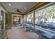 Expansive screened-in porch with ceiling fans, offering a relaxing view of the trees and lake at 19529 Dorr Rd, Altoona, FL 32702
