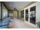 Spacious screened porch with ceiling fans and access to the outdoors through elegant glass doors at 19529 Dorr Rd, Altoona, FL 32702