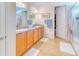 Bright bathroom featuring a double sink vanity, tile flooring and a shower-tub combination at 316 Treviso Dr, Poinciana, FL 34759