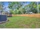 Spacious backyard with a wooden fence, lush lawn, and a covered patio area at 1318 Terre Cia Ave, Orlando, FL 32807