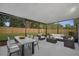 Stylishly furnished screened patio provides a comfortable outdoor living space with dining and lounge areas at 1318 Terre Cia Ave, Orlando, FL 32807
