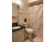 Cozy bathroom featuring a vanity with granite counters, a modern toilet, and a shower with decorative curtain at 2647 Surrey Ct # 2647, Kissimmee, FL 34741