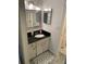 Bright bathroom with updated vanity, granite countertop, decorative mirror and neutral decor at 2647 Surrey Ct # 2647, Kissimmee, FL 34741