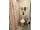 Cozy bathroom featuring a toilet with a decorative shower curtain at 2647 Surrey Ct # 2647, Kissimmee, FL 34741
