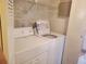 Well-lit laundry room with a washer and dryer, featuring wire shelving for storage at 2647 Surrey Ct # 2647, Kissimmee, FL 34741