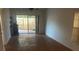 Bright living room featuring wood flooring, sliding glass doors, and backyard access at 2647 Surrey Ct # 2647, Kissimmee, FL 34741
