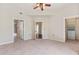 Spacious bedroom with neutral carpet, ceiling fan, walk-in closet, and attached bathroom at 501 Mirasol Cir # 424, Celebration, FL 34747