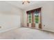 Cozy bedroom featuring neutral carpet, ceiling fan, and bright windows at 501 Mirasol Cir # 424, Celebration, FL 34747