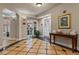 Welcoming hallway with tiled floors, a table with brochures, and a fitness center entrance at 501 Mirasol Cir # 424, Celebration, FL 34747