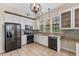 Kitchen boasts white cabinetry, stainless steel appliances, stone backsplash and granite countertops at 501 Mirasol Cir # 424, Celebration, FL 34747