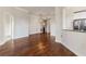 Open-concept living room features hardwood floors, elegant lighting, and an open doorway at 501 Mirasol Cir # 424, Celebration, FL 34747
