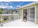 View from back porch into bedroom with sliding glass door entry and green facade at 3145 Britannia Blvd # D, Kissimmee, FL 34747
