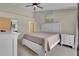 Bedroom with a white bed frame, neutral walls, ceiling fan, and two night stands at 3145 Britannia Blvd # D, Kissimmee, FL 34747