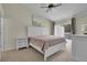 Bedroom with a white bed frame, neutral walls, ceiling fan, and sliding glass door to the outside at 3145 Britannia Blvd # D, Kissimmee, FL 34747
