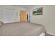 Main bedroom featuring a neutral color scheme, mounted television, and plush bed at 3145 Britannia Blvd # D, Kissimmee, FL 34747