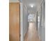 Inviting hallway with wood flooring leading to the living room with large windows at 3145 Britannia Blvd # D, Kissimmee, FL 34747