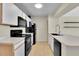 Bright kitchen featuring white cabinets, black appliances, tile floors, and laminate countertops at 3145 Britannia Blvd # D, Kissimmee, FL 34747