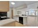 Well-lit kitchen with black appliances and an eat-in kitchen island overlooking the spacious living room at 3145 Britannia Blvd # D, Kissimmee, FL 34747