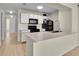 Modern kitchen with black appliances, white cabinets, and a functional breakfast bar at 3145 Britannia Blvd # D, Kissimmee, FL 34747