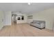 Bright living room featuring modern floors, sleek shelving, and a comfortable couch at 3145 Britannia Blvd # D, Kissimmee, FL 34747