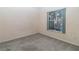 Simple carpeted bedroom with a window overlooking an outdoor pool area at 162 Seneca Point Trl, Kissimmee, FL 34746