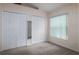 Neutral bedroom featuring double closets, a window with blinds, and plush carpet at 162 Seneca Point Trl, Kissimmee, FL 34746