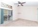 A bedroom with carpeted floor, a sliding glass door to the patio, and a ceiling fan at 162 Seneca Point Trl, Kissimmee, FL 34746