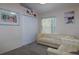 Bright bedroom with closet and window, featuring a cream-colored sofa and chair at 162 Seneca Point Trl, Kissimmee, FL 34746