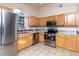 Charming kitchen features stainless steel appliances and bright tile floors at 162 Seneca Point Trl, Kissimmee, FL 34746