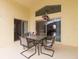 Outdoor patio seating area with table and chairs under a covered space at 162 Seneca Point Trl, Kissimmee, FL 34746