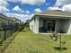 Lawn and partially fenced backyard with patio and grassy area at 4183 Cortland Dr, Davenport, FL 33837