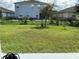 Spacious fenced backyard showing grass and seating area at 4183 Cortland Dr, Davenport, FL 33837
